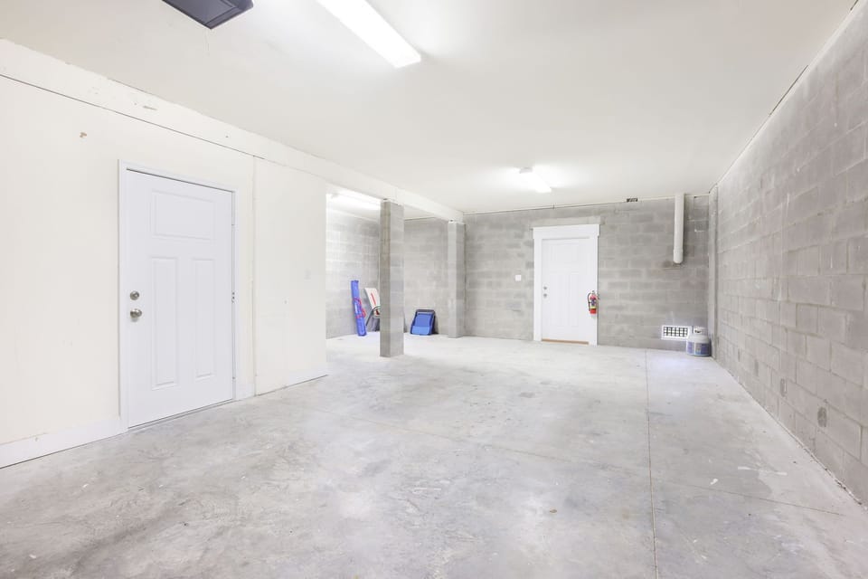 Garage can fit up to two cars end-to-end. Backdoor leads to outdoor grill area.