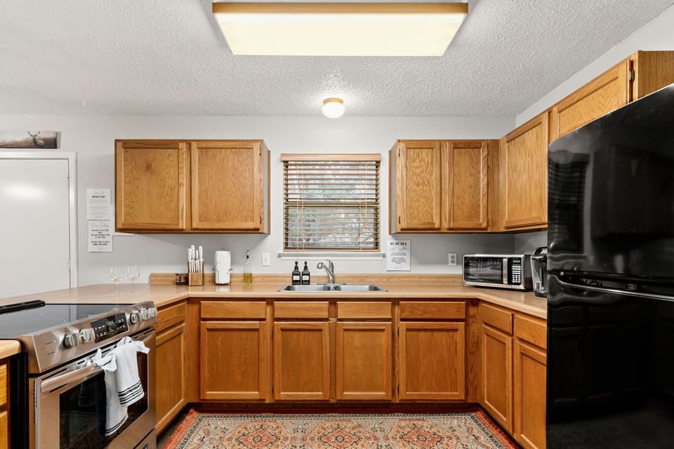 Our spacious kitchen includes a fully stocked coffee bar and new appliances.