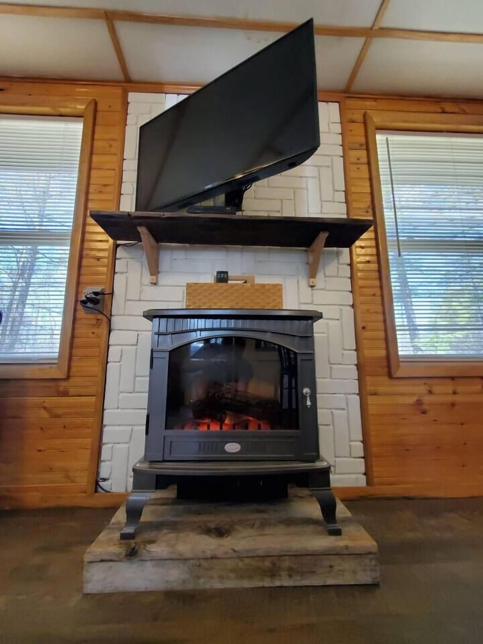 Electric log stove  and tv in the living room and dining area.