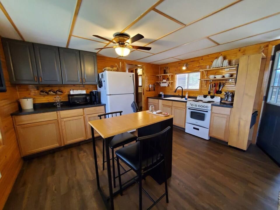 Kitchen with stove, refrigerator, microwave and Keurig. Dining/eating area.
