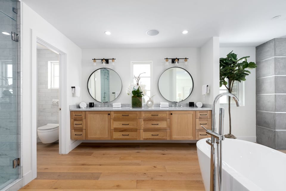 Primary bathroom with two sink, free standing tub and multi-valve shower. 