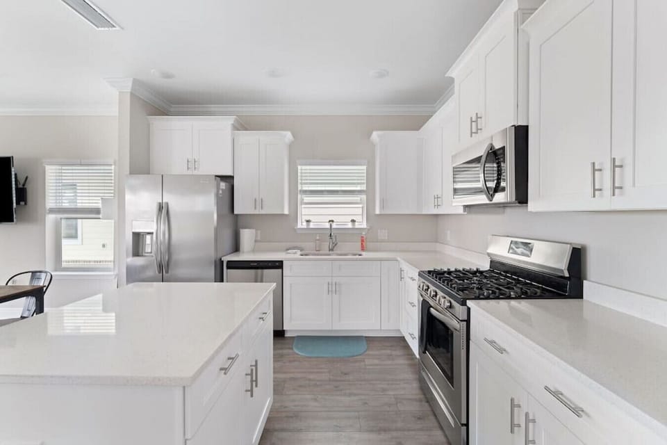 Fully equipped kitchen with all cooking and baking supplies, gas stove, and dishwasher. Grill tools available for outdoor grill. Dining area seats 6 with 4 at the table and 2 at kitchen island. Regular drip coffee maker.