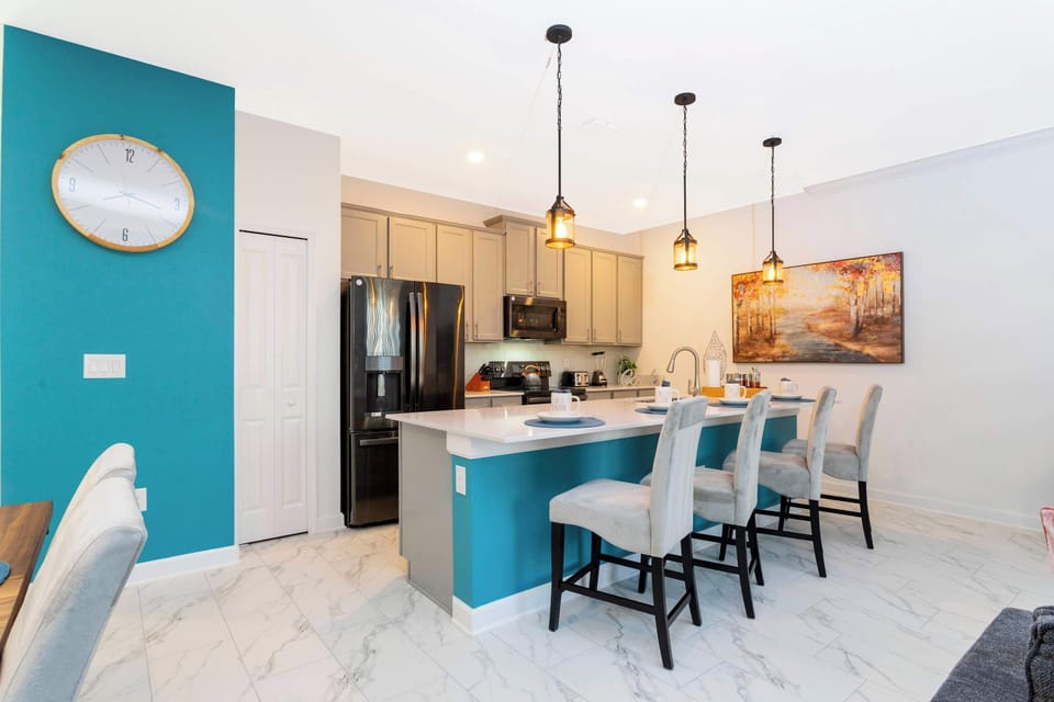 The stylish kitchen island offers extra seating and a great spot for morning coffee. The open design keeps the whole family connected.