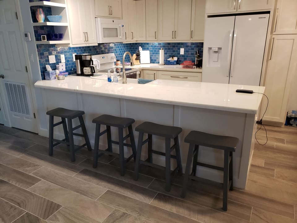 The breakfast bar has seating for 4 additional people.