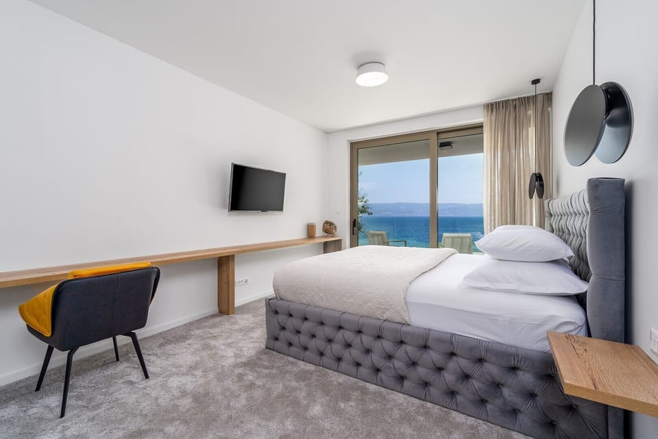 Master Bedroom No5 (South, 22sqm) offering amazing sea and pool views, with a King size bed 200cm x 200cm, a TV