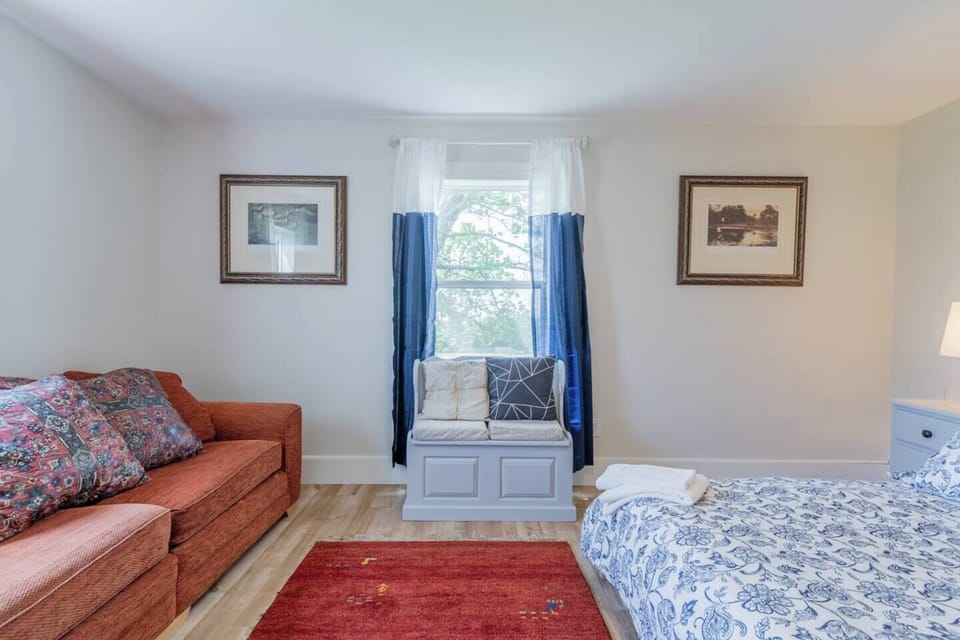 Bedroom 1 with queen bed & sofa, sitting arrangements