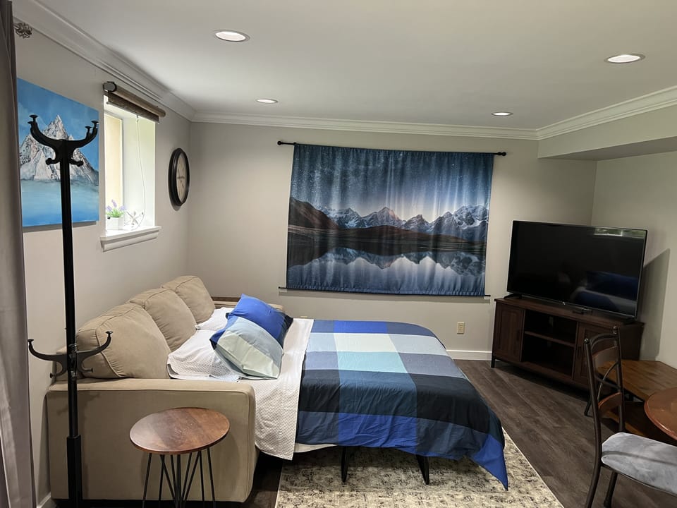 Living room couch pulls out to become a second queen size bed.