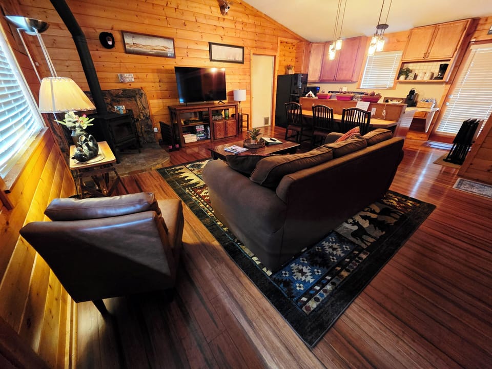 The view of our living room with comfortable couch, TV, chair and more. ©