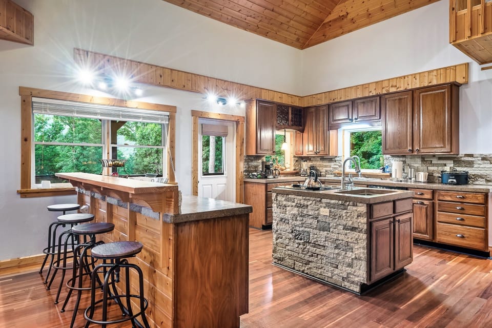 Gourmet kitchen with plenty of space to meal prep and unique bar with bar stools