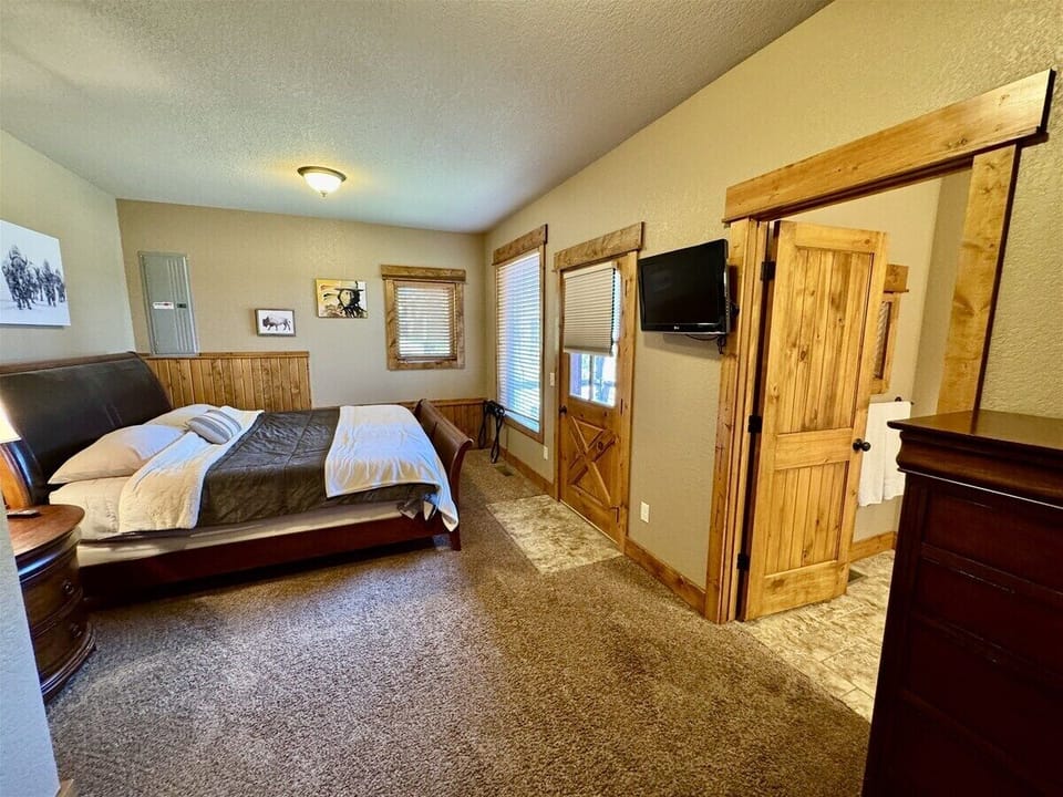 Lower level bedroom 3 with king bed, tv, attached bath