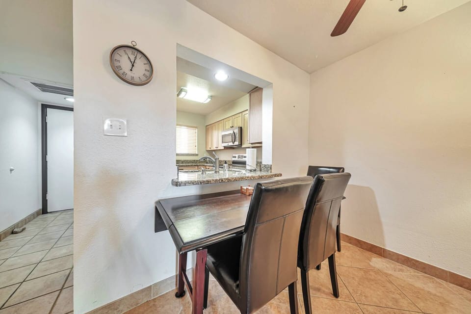 Dining table just off the living room features 3 chairs w/ another chair in bedroom to use