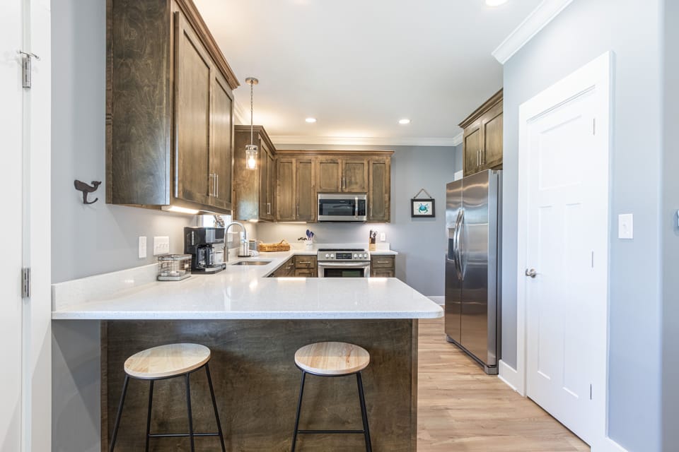 Kitchen - Upon entry you will be welcomed by a spectacular kitchen that is fully stocked with all items needed for meal prepping.