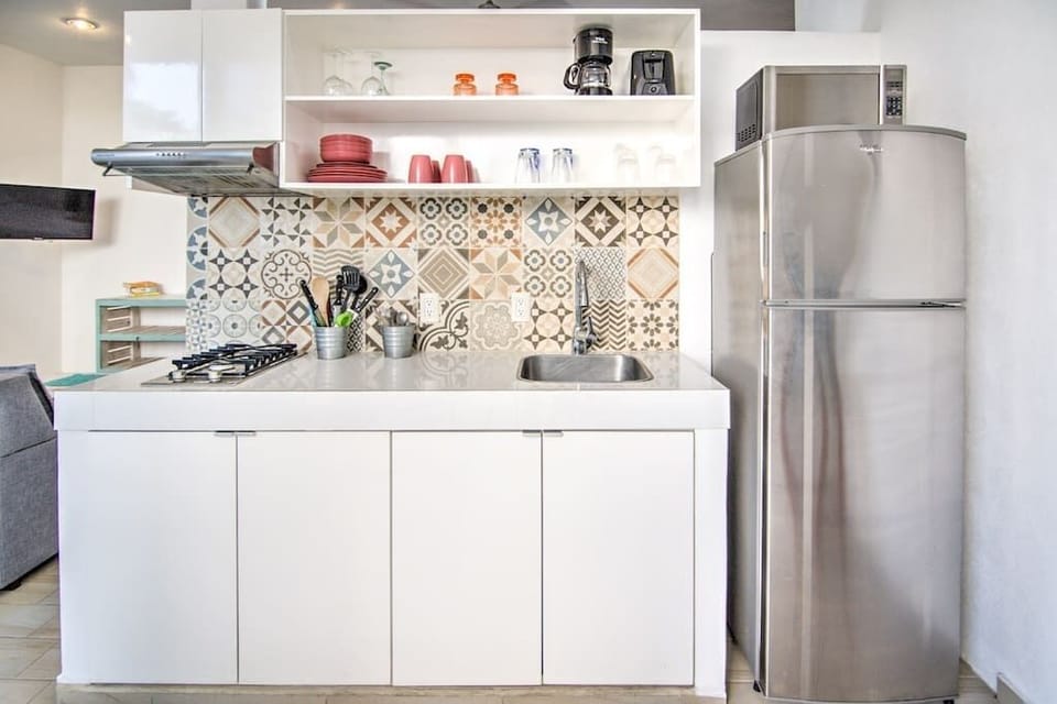 Fully-equipped kitchen with stainless steel appliances, filtered water, coffee maker, and all the utensils you could need.