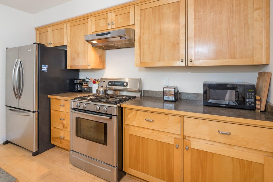Full kitchen with gas stove, microwave and french door fridge.