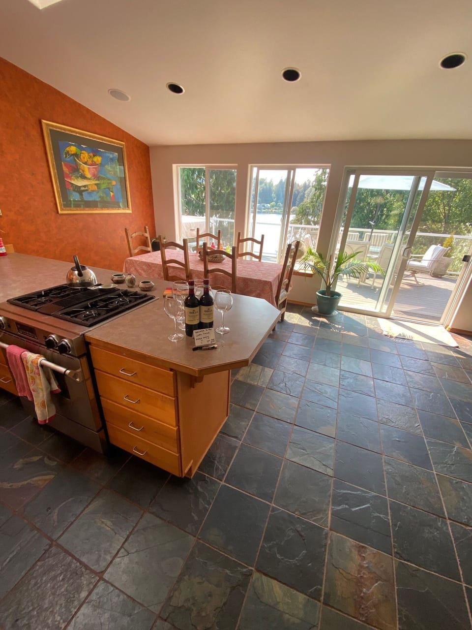 Dining room overlooking lake w/ views with large table seats 6 + 2 stools avail