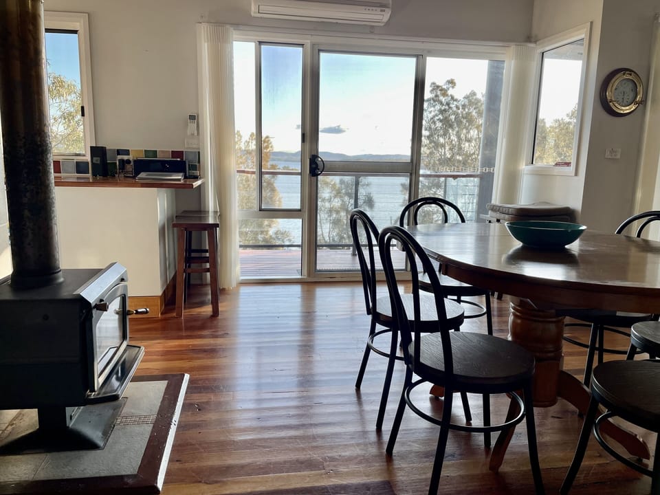 A wood fire in winter or open windows in summer with stunning lake views.