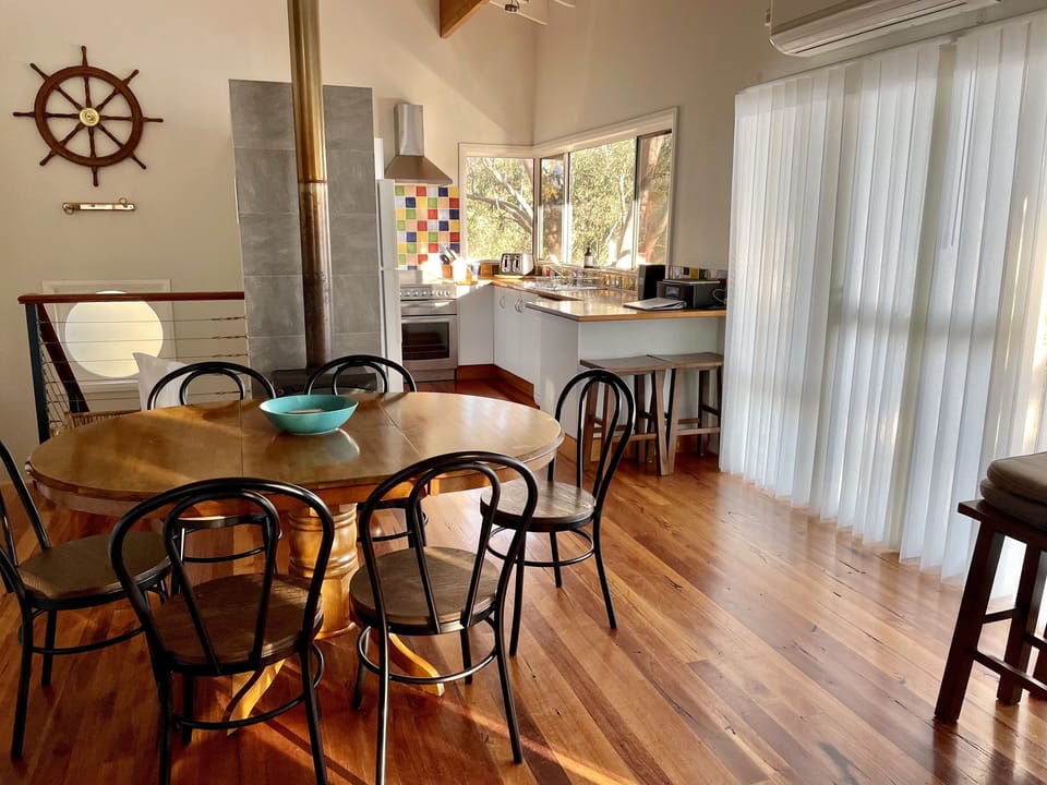 With timber floors and vaulted ceilings, the space with wood fire is so cozy.