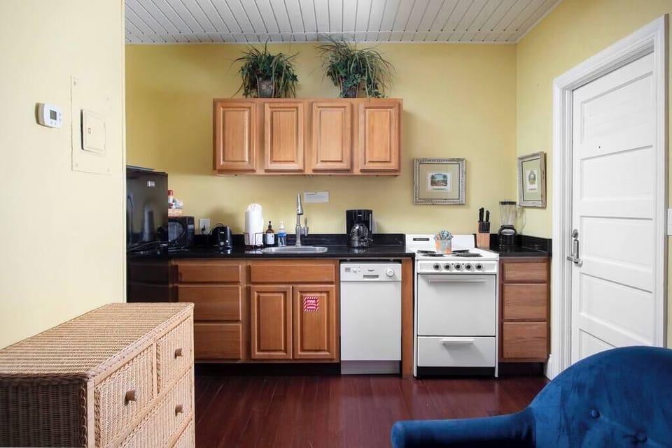 Full Kitchen with stove, oven pots, pans, and coffee maker, microwave, blender, toaster, dish soap, hand soap