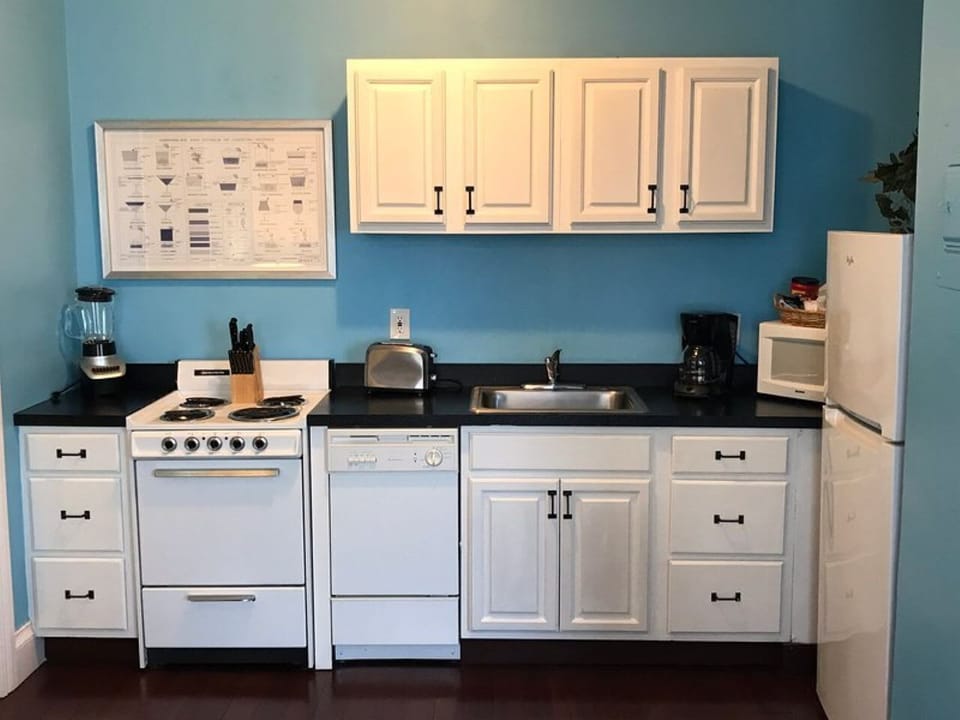 Mile Zero suite full kitchen with fridge, stove, microwave, dishwasher, blender, toaster, dinner plates, small plates, cups, mugs, pots, pans, paper towels, hand soap and dish soap