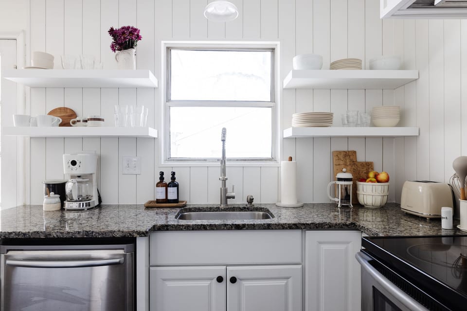 Coffee machine, french press, and coffee grounds provided. 