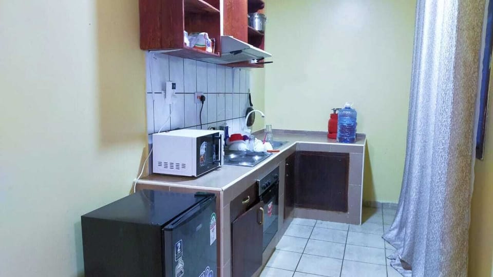 Family House | Private kitchen | Fridge, microwave, cookware/dishes/utensils, dining tables