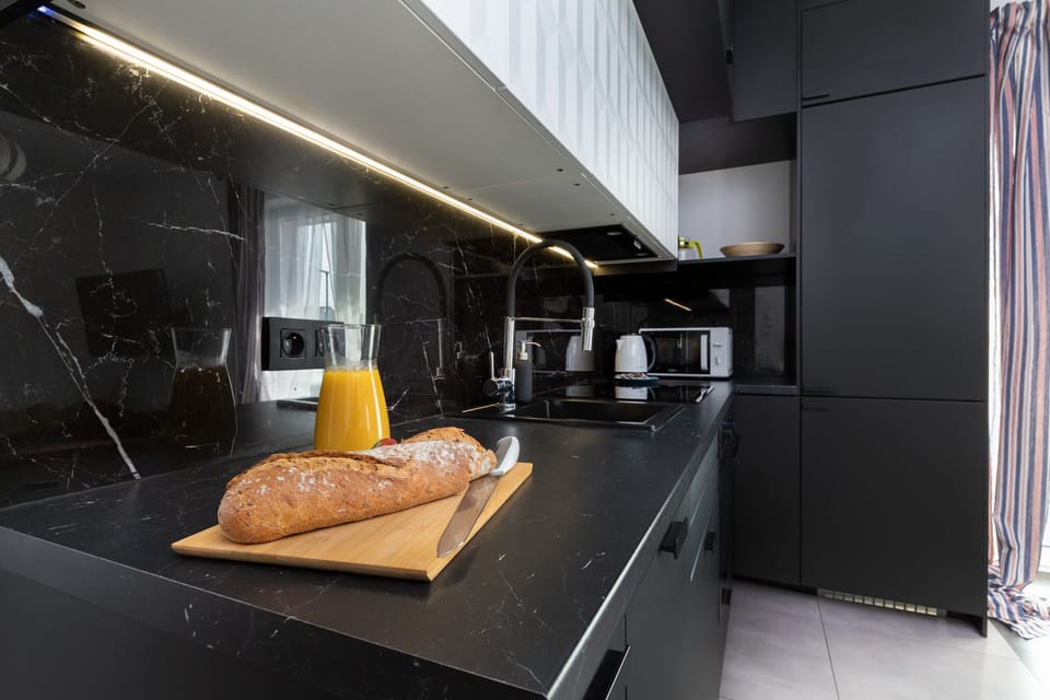 A close-up of a modern kitchen counter with fruit and sleek lighting.