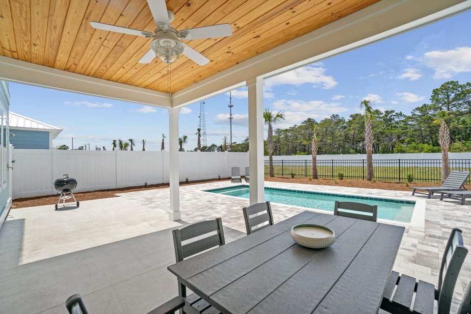 Relax at your private dining table while overlooking your sparkling pool and peaceful lake views beyond.