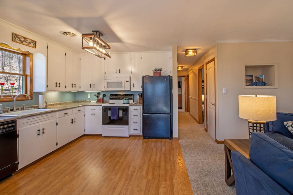 Three bedrooms and full bathroom located off of kitchen area