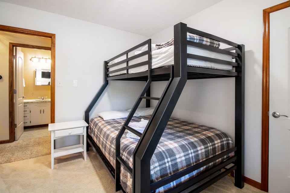 Bedroom includes one twin over full bunk bed and a tv