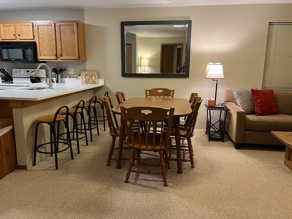 Dining table seats 6; counter bar has 4 stools