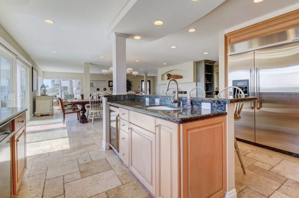 Kitchen features two sinks, stainless appliances, walk-in pantry, and gas stove.