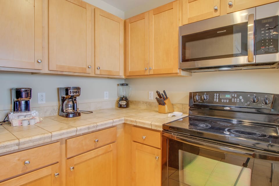 This kitchen features a standard coffee pot + single serve coffee maker!