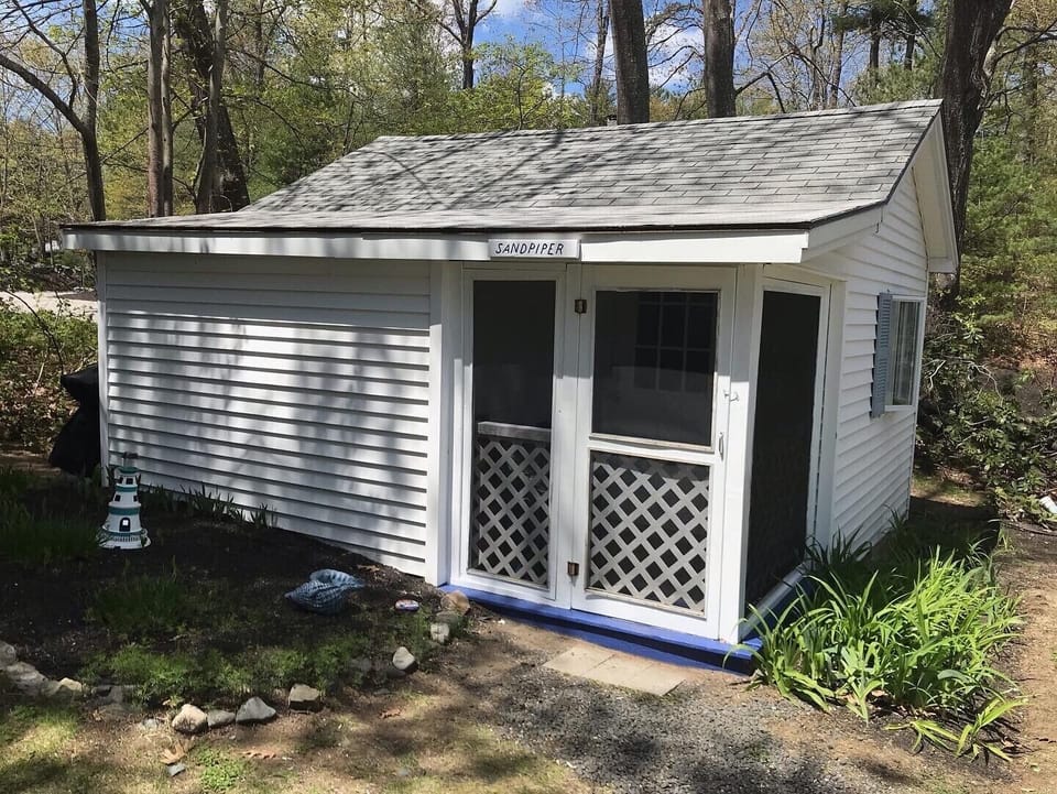 Cozy screened in porch! Perfect for enjoying that cup of morning coffee!