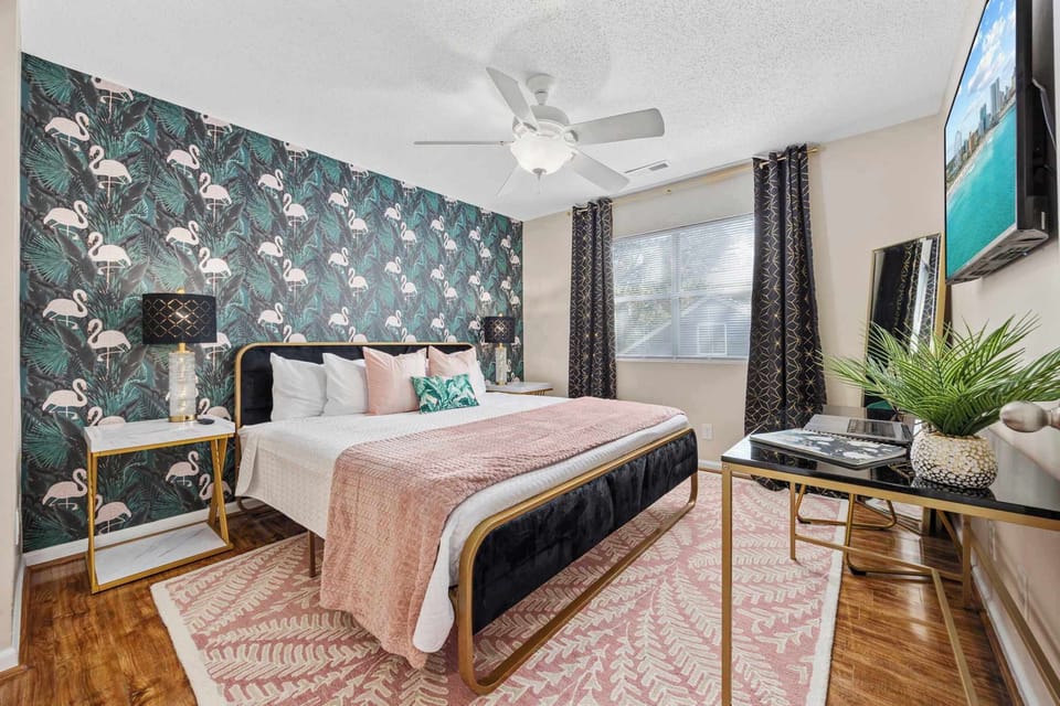 Primary bedroom with king bed, work-from-home desk, smart Roku TV, walk in closet and ensuite bathroom with shower tub.