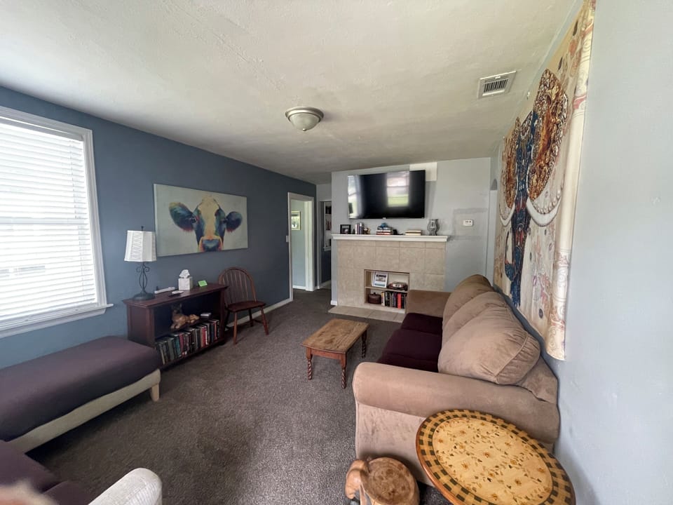 Living room with view through to kitchen and dining areas.
