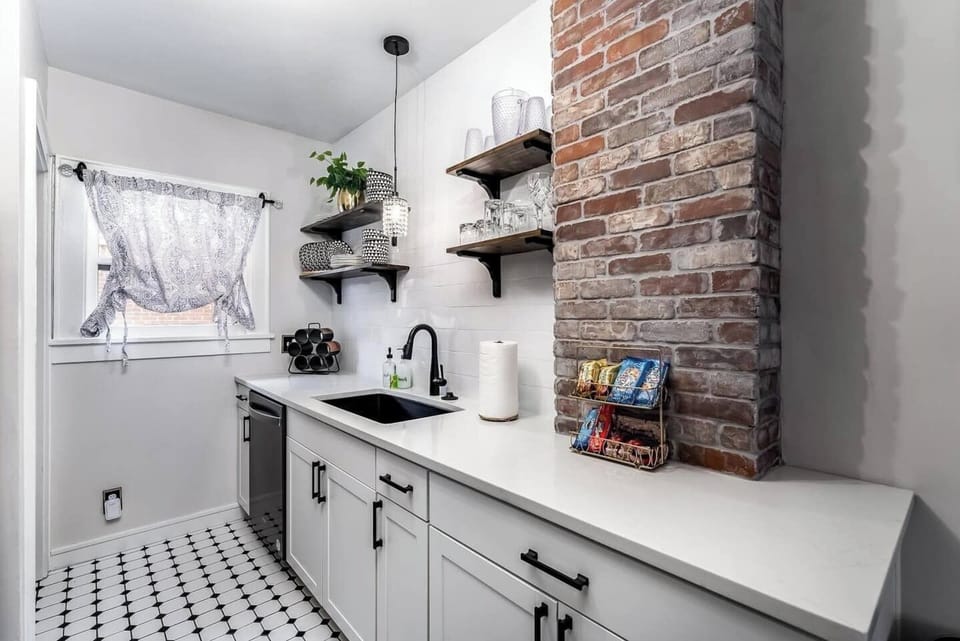 Beautiful kitchen stocked with dishwasher, pots, pans, dinnerware
