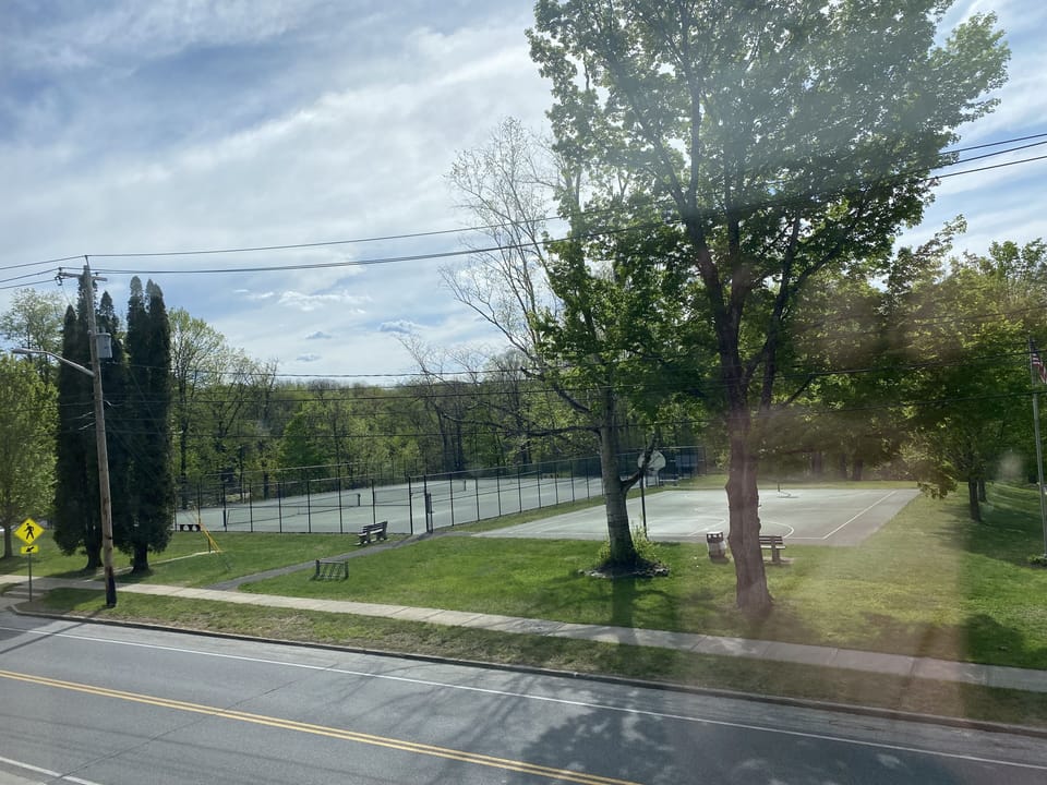 Tennis courts and basketball court in park across the street