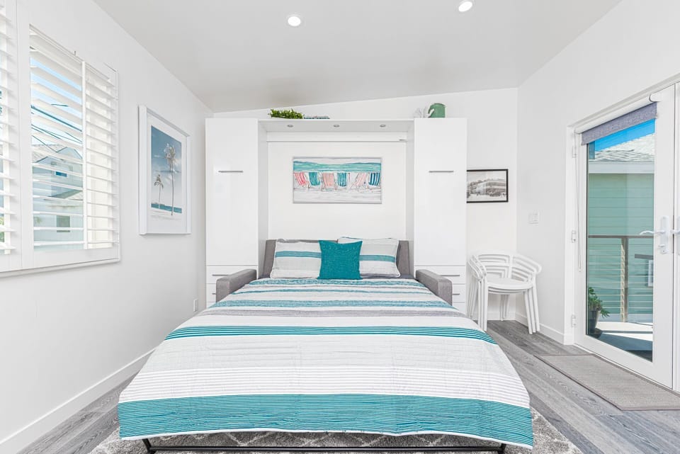 The sofa opens up into a queen Murphy bed and is flanked with built-in storage.
                