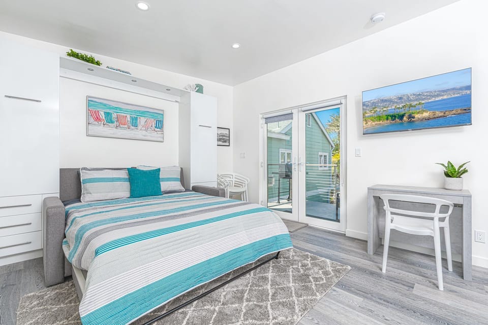 The sofa opens up into a queen Murphy bed and is flanked with built-in storage.
                