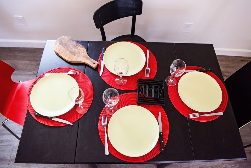 Chairs, crockery and cutlery for four people.