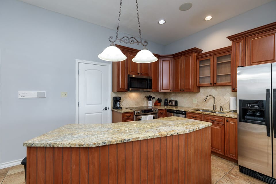 Your gourmet kitchen awaits with rich cherry cabinets, granite countertops, and stainless steel appliances - perfect for preparing memorable meals.