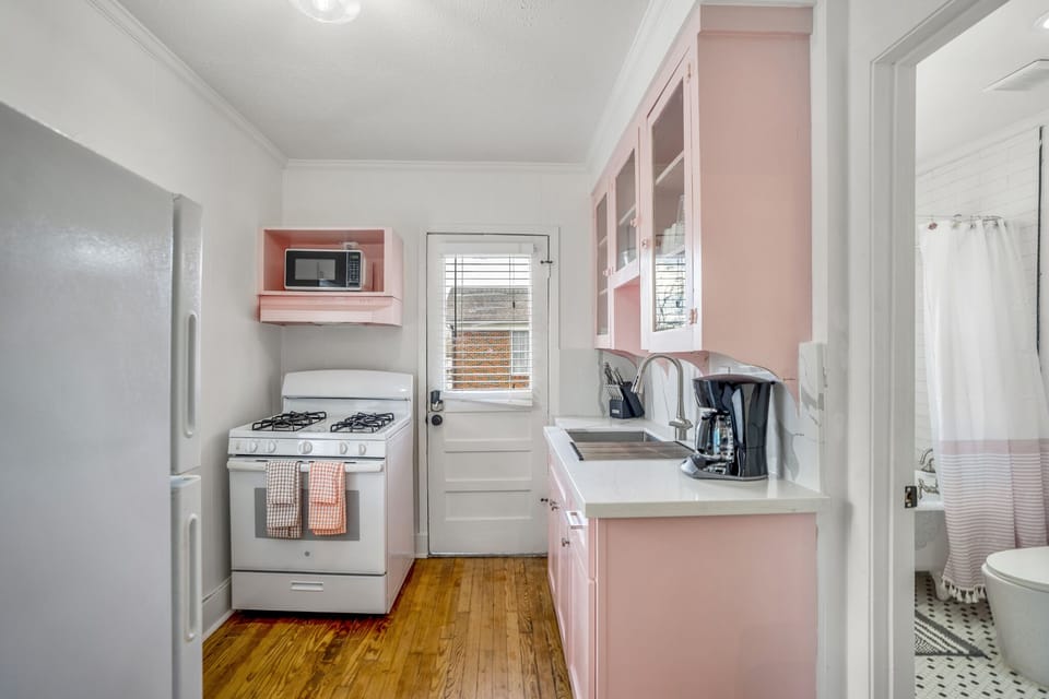 Fully stocked kitchen with all appliances and utensils.