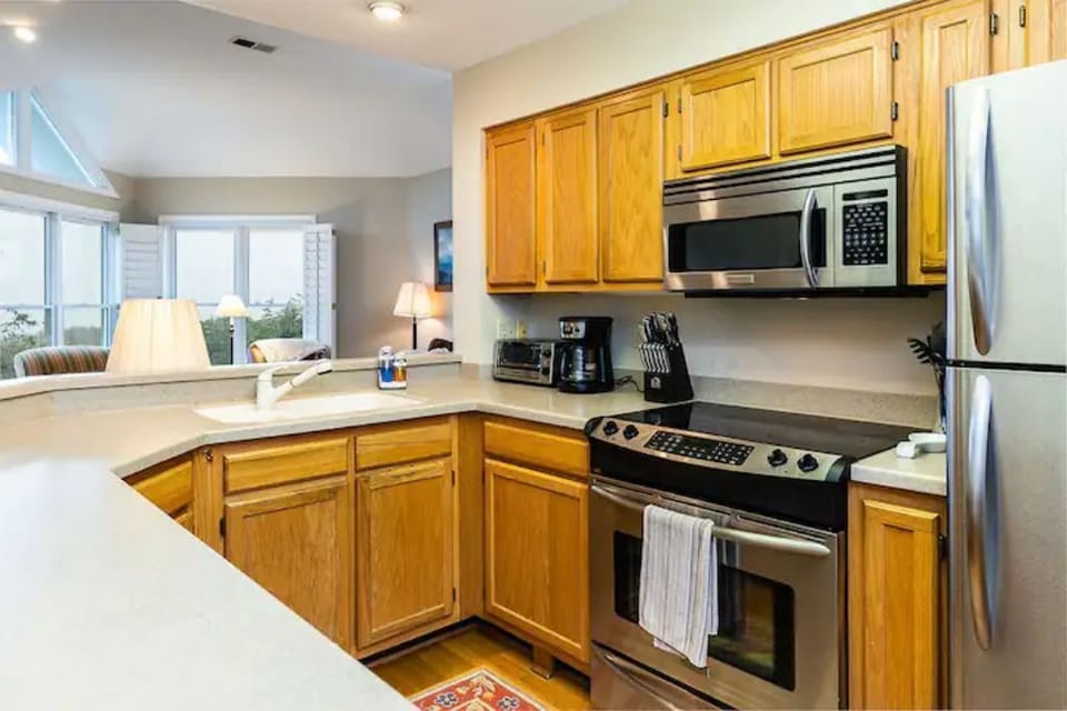 Open plan among living room, kitchen and dining room allows easy flow for all.
