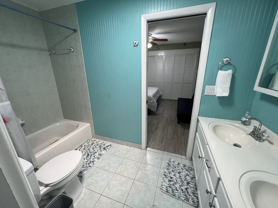 Jack and Jill Bath room with Shower bathtub and 2 sinks and mirrors 