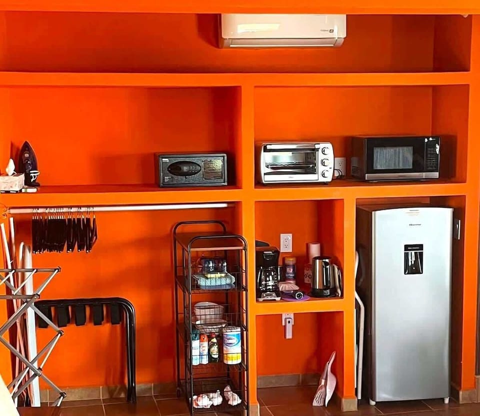 Open design closet and shelves with wood hangers, luggage racks, personal safe, kitchenette with toaster oven, microwave, medium sized fridge with small freezer section,  coffeemaker, electric water kettle, fresh coffee from Chiapas, and fresh milk!