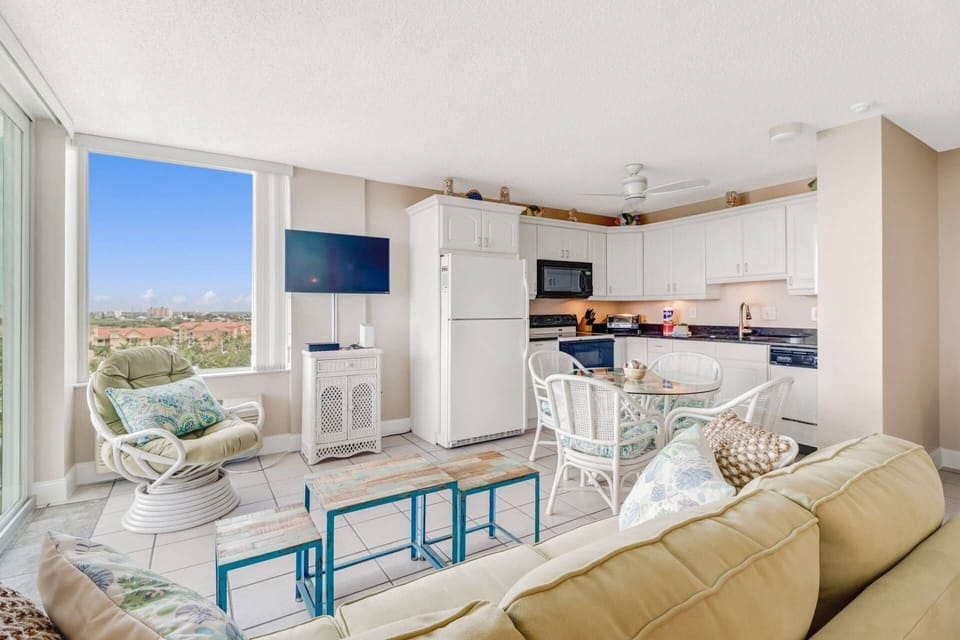 The TV in the living area is viewable from the bed in the sleeping space.