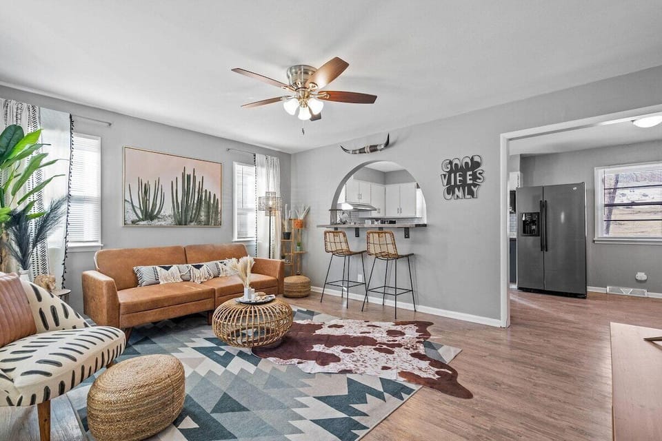 Spacious Open-Concept Main/Upstairs Living Area with Cozy Seating, Large Windows, and Plenty of Natural Light.