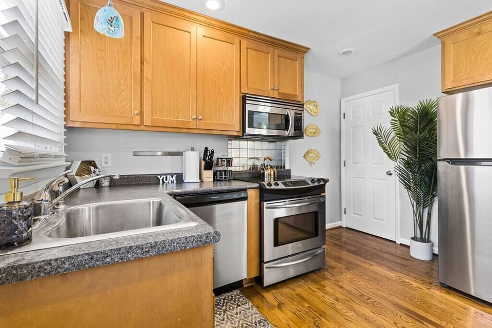 Bright kitchen with modern appliances and direct access to the back parking space and living areas