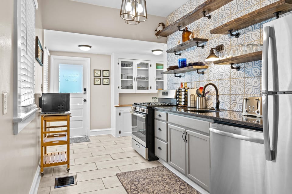 Bright, fully equipped kitchen with plenty of counter space—perfect for cooking at home during your KC getaway.