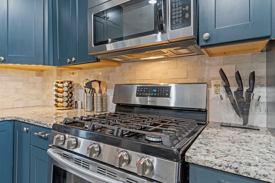 Main-Floor Kitchen designed for convenience with a gas range, large fridge, and bright workspace. Ideal for guests exploring walkable Westport and the 39th Street entertainment district.